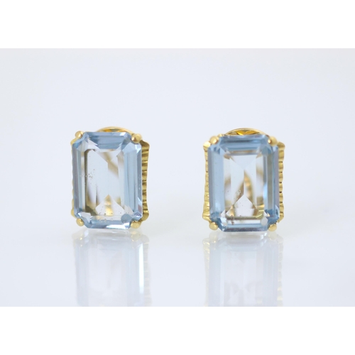 178 - A pair of blue synthetic spinel earrings, the emerald cut blue stones claw set in yellow metal with ... 