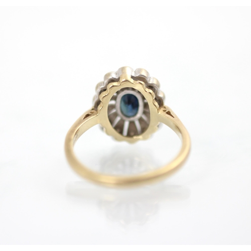 189 - A 9ct yellow gold untested sapphire and diamond cluster ring, the oval cut blue stone with stylised ... 