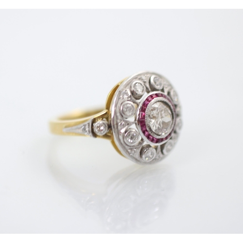 192 - An Art Deco style diamond and ruby target ring, the central round cut diamond within a surround of c... 