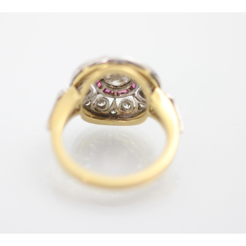 192 - An Art Deco style diamond and ruby target ring, the central round cut diamond within a surround of c... 