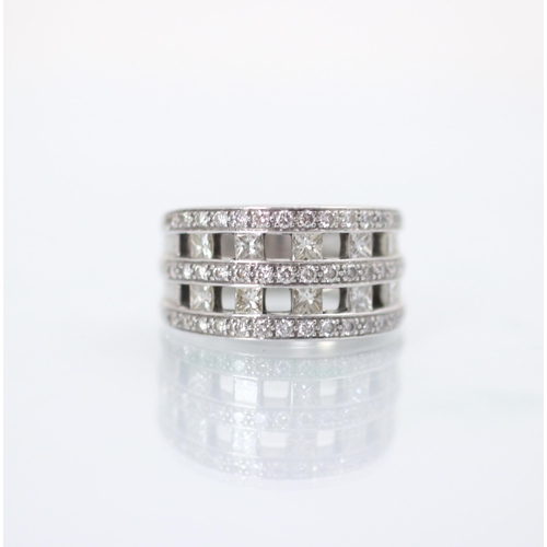 195 - A diamond dress ring, the ten princess cut diamonds channel set within triple border of round cut di... 