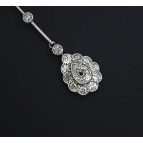 198 - An early 20th century pear cut diamond pendant, the central pear cut diamond within surround of ten ... 