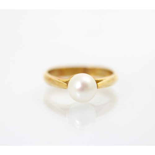 205 - A yellow metal and untested cultured pearl dress ring, the spherical pearl with tapered shoulders an... 