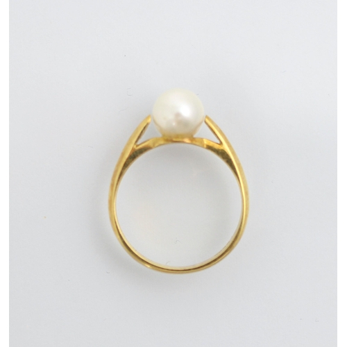 205 - A yellow metal and untested cultured pearl dress ring, the spherical pearl with tapered shoulders an... 