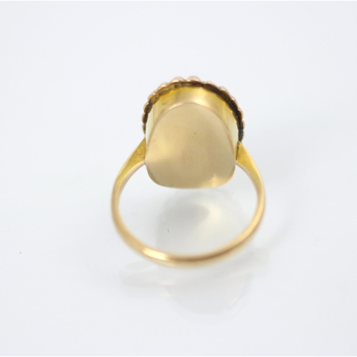 207 - A 19th century style foiled back ring, the oval cut apricot stone within a surround of twenty split ... 