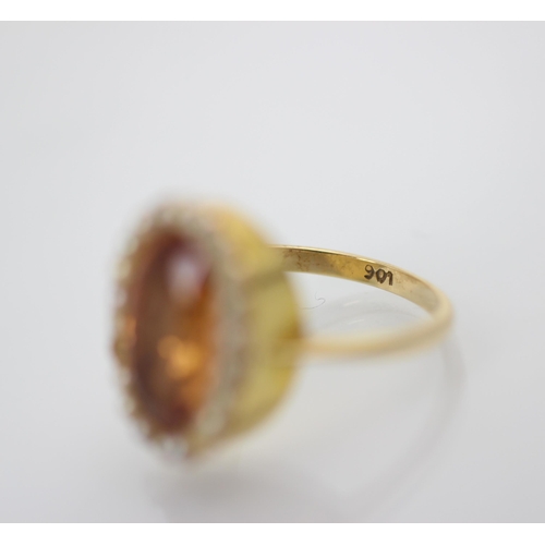 207 - A 19th century style foiled back ring, the oval cut apricot stone within a surround of twenty split ... 