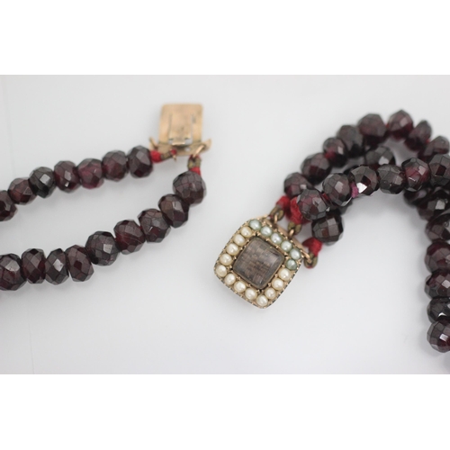 209 - A 19th century style triple strand necklace, the faceted red stones of non uniform spherical shape, ... 