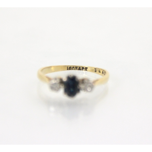 212A - An Edwardian style untested sapphire and diamond three stone ring, the central oval cut blue stone w... 