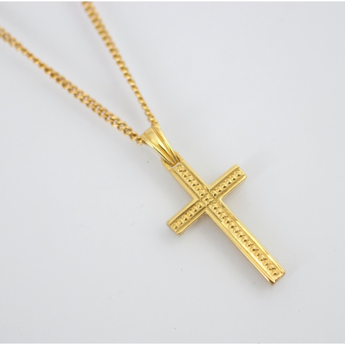 213 - A yellow metal cross pendant, the front of the cross with beaded detail and plain to reverse, stampe... 