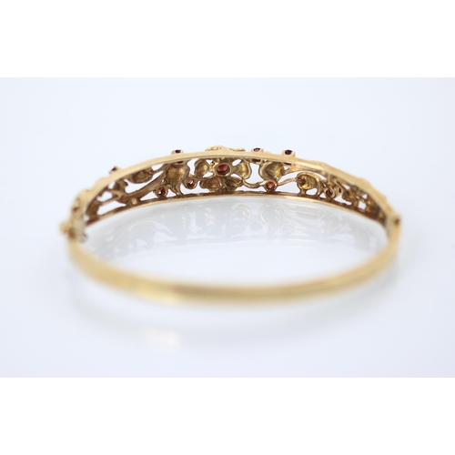 224 - A 9ct yellow gold Victorian style bangle, the openwork bangle with flowerhead and foliage detail, se... 