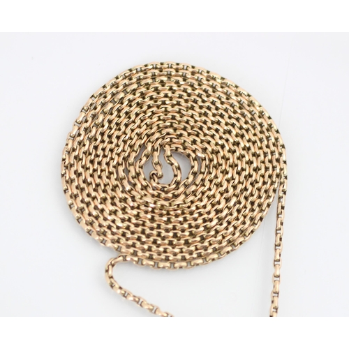 228 - An early 20th century yellow metal long guard chain, the lightly faceted oval links with lobster fas... 