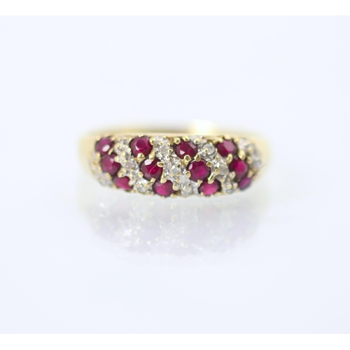 230 - A 9ct yellow gold diamond and ruby dress ring, the nine stripes of round cut diamonds and rubies set... 