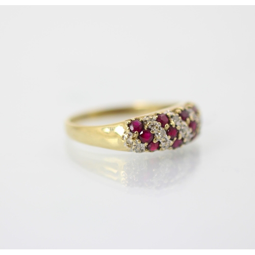 230 - A 9ct yellow gold diamond and ruby dress ring, the nine stripes of round cut diamonds and rubies set... 