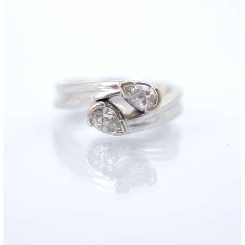 239 - A pear cut diamond 'toi et moi' ring, the two pear cuts set in white metal rub over mount leading to... 