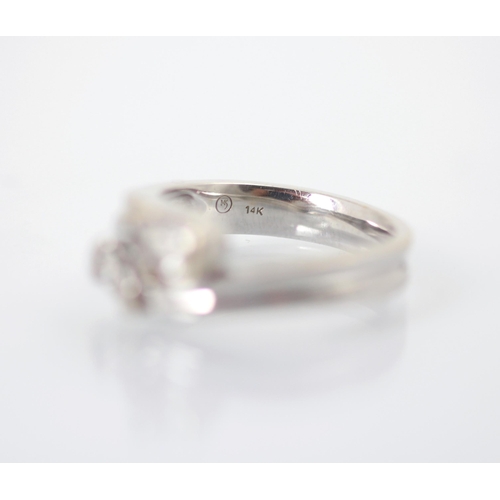 239 - A pear cut diamond 'toi et moi' ring, the two pear cuts set in white metal rub over mount leading to... 