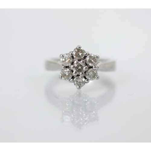 241 - A mid 20th century diamond set cluster ring, the central round cut diamond within surround of six ro... 