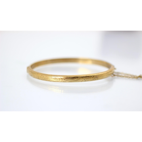 248 - A 9ct yellow gold bangle, the hollow bangle with engraved detail to exterior, stamped ‘JS’ Chester 1... 