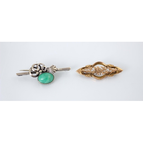 261 - A Gottfred Henry Hoppe brooch, the stylised openwork brooch with green hardstone oval cabochon, stam... 