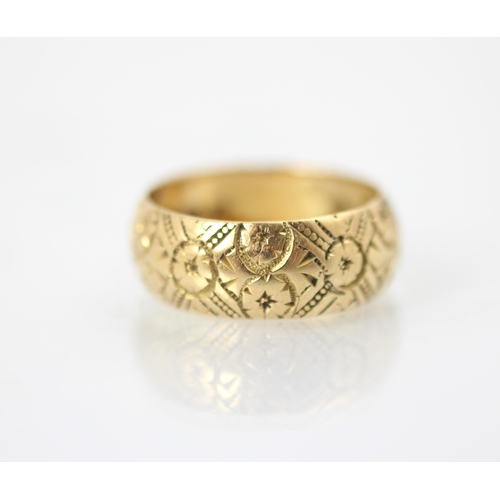 262 - A Victorian 18ct yellow gold ring, with continuous floral engraved detail, stamped indistinctly, Bir... 