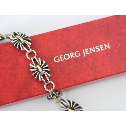 264 - A Georg Jensen bracelet, designed by Lene Munthe, the five openwork oval links with gold coloured ba... 