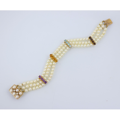 270 - An untested cultured pearl bracelet, the triple strand of uniform spherical beads with four yellow m... 