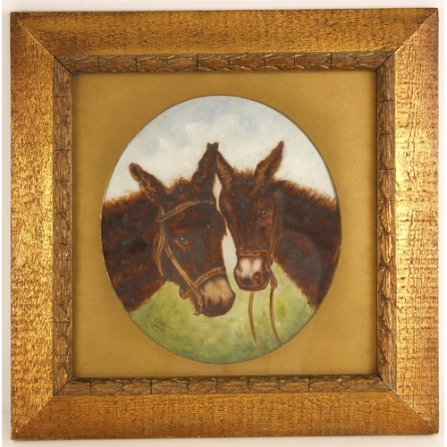 297 - E.M. Pixton (British, late 19th/early 20th century),  
A naïve study of two donkeys,  
Oval mounted ... 