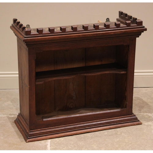 806 - A Victorian Gothic revival pitch pine wall shelf in the Puginesque manner, the castellated cornice o... 