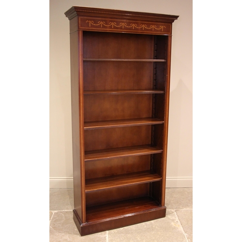 810 - An Edwardian style open bookcase, late 20th century, with a moulded and dentil cornice over a frieze... 