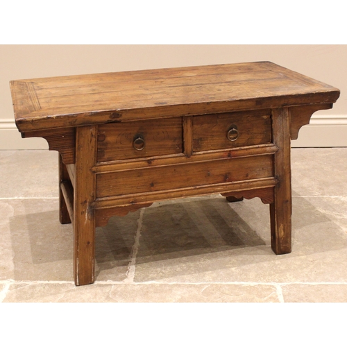 816 - A Chinese elm Kang type coffee table, early 20th century, the cleated oversailing plank top above tw... 