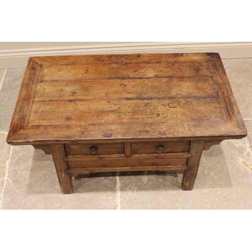 816 - A Chinese elm Kang type coffee table, early 20th century, the cleated oversailing plank top above tw... 