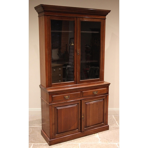 824 - An Edwardian walnut library bookcase, with a moulded dentil cornice over a pair of glazed doors open... 