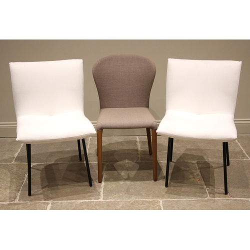 851 - A pair of Ligne Roset dining chairs, early 21st century, upholstered in white fabric upon splayed pa... 