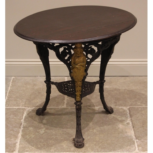 882 - A Victorian cast iron Britannia pub table, the oval hardwood top upon three supports cast with a fig... 