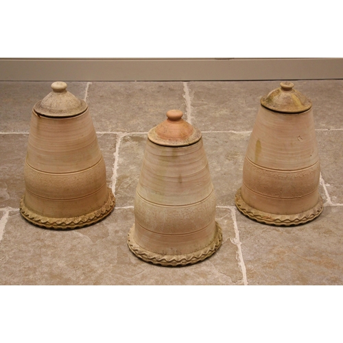 889 - A trio of terracotta rhubarb forcers, each of bell form with pie crust rim and removable covers, 43c... 