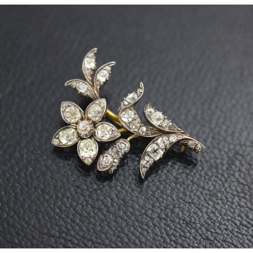 136 - A late 19th century diamond set spray brooch, designed as a flower with old cut diamonds set through... 