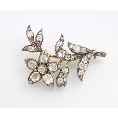 136 - A late 19th century diamond set spray brooch, designed as a flower with old cut diamonds set through... 