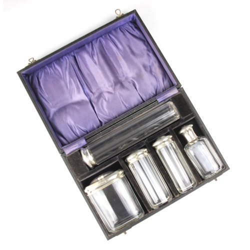 16 - A cased set of George V silver mounted dressing table jars, Henry Perkins & Sons, London 1929, the c... 