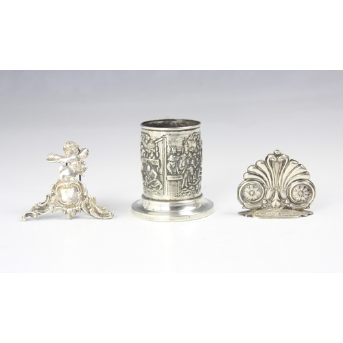 66 - A Dutch silver plated pen tidy, of cylindrical form, embossed with figures and animals, upon a circu... 