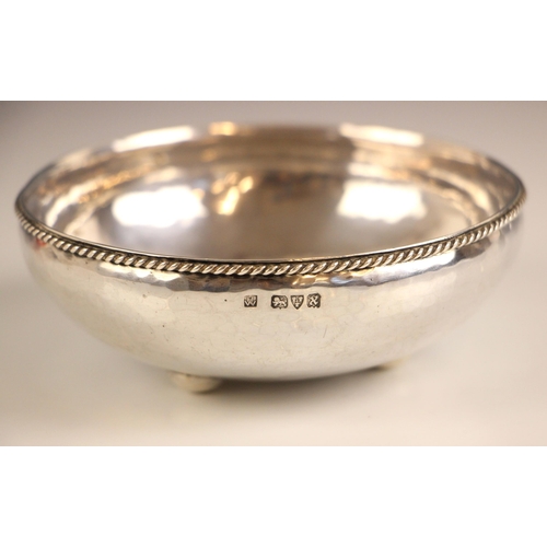 9 - A George VI Arts and Crafts style silver bowl, Hugh Wallis, Chester 1948, the rope work rim above a ... 