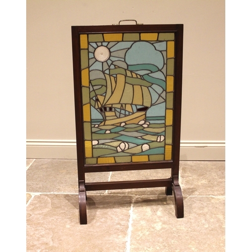 829 - An Arts & Crafts leaded and coloured glass fire screen, depicting a galleon in full sail, within a p... 