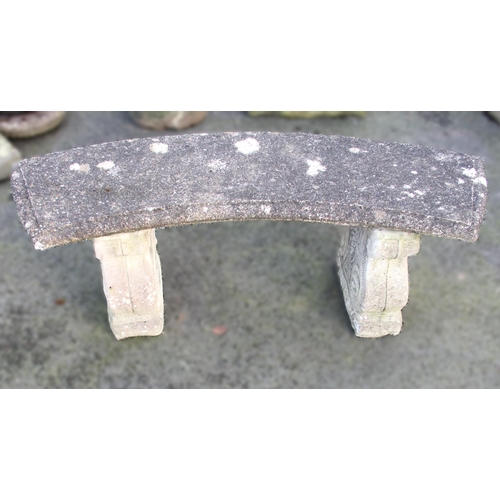 873 - A reconstituted stone bench, of curved form, upon twin scroll moulded pedestal supports, 43cm H x 11... 