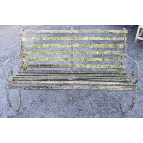 877 - An Edwardian slatted garden bench, with wrought iron scroll supports, 90cm H x 152cm W