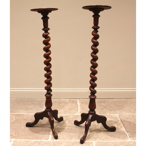 808 - A pair of Victorian mahogany torcheres, each with a moulded circular tray top upon a barley twist co... 