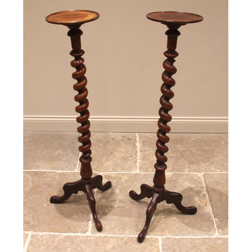 808 - A pair of Victorian mahogany torcheres, each with a moulded circular tray top upon a barley twist co... 