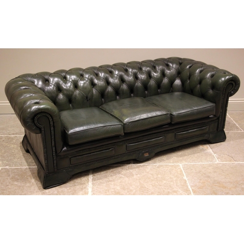 855 - A green leather Chesterfield sofa, by Waring and Gillow, mid to late 20th century, the scrolled butt... 