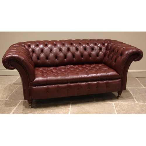 858 - A Chesterfield red leather sofa, late 20th/early 21st century, each of typical deep seated form, wit... 