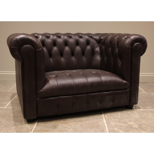 859 - A Chesterfield nut brown leather tub armchair, late 20th/early 21st century, of country house propor... 