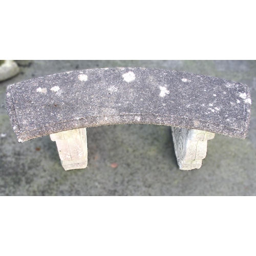 873 - A reconstituted stone bench, of curved form, upon twin scroll moulded pedestal supports, 43cm H x 11... 