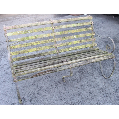 877 - An Edwardian slatted garden bench, with wrought iron scroll supports, 90cm H x 152cm W