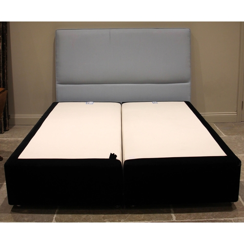 843 - A Heal's twin section bed base with headboard, the base in black velour fabric, each section upon si... 